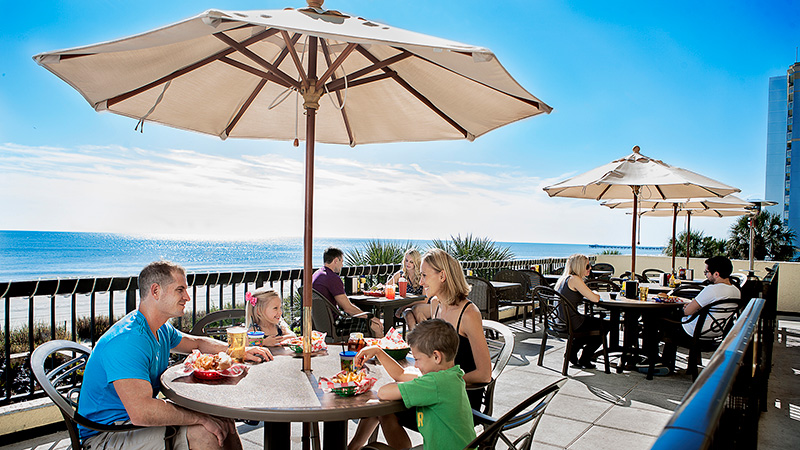 Compass Cove family enjoying Crows Nest oceanfront dining