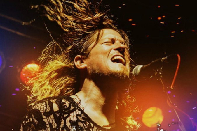 Singer at microphone with hair flying around