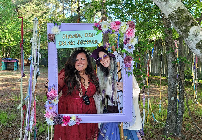 Two ladies dressed in Celtic dresses