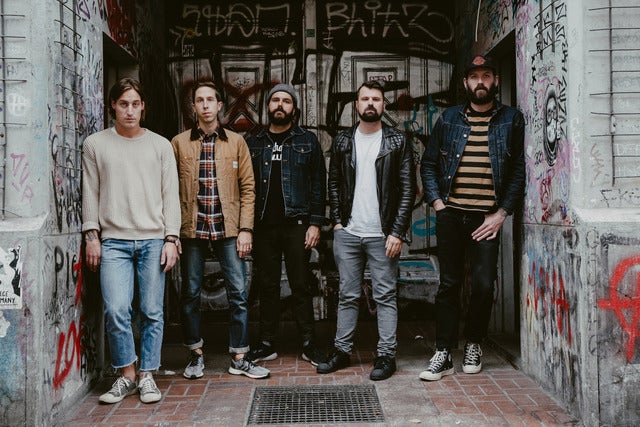 The group standing in graffiti doorway