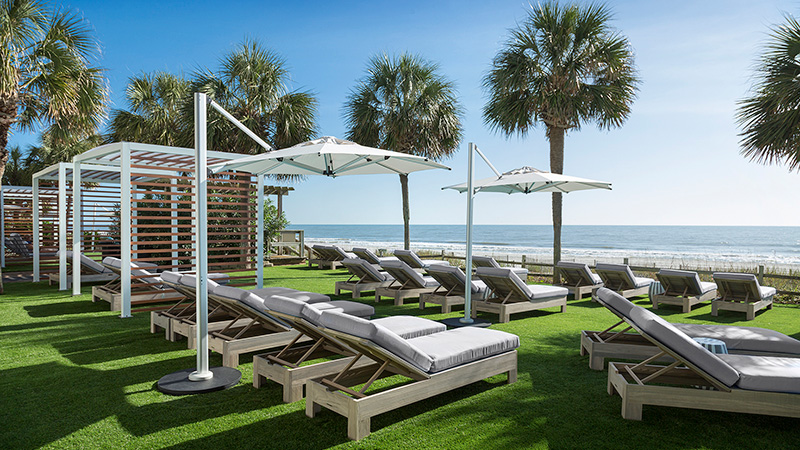 The Strand oceanfront lawn with lounge chairs