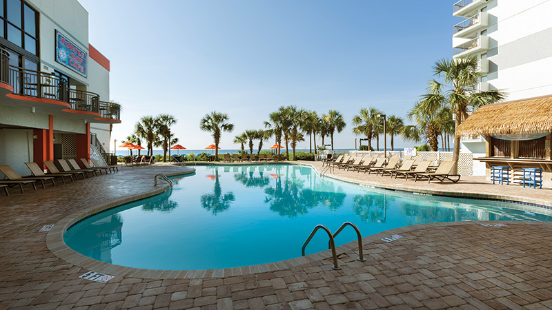 Grande Cayman Resort oceanfront pool with palm trees