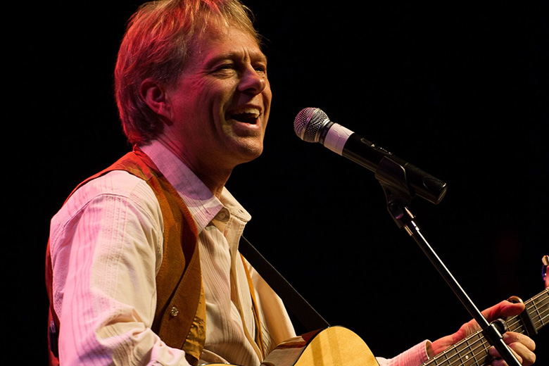 Tom Becker on stage with guitar