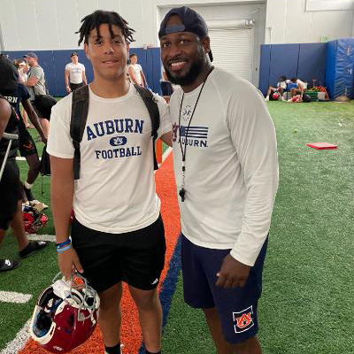 Auburn players in practice gear at indoor field