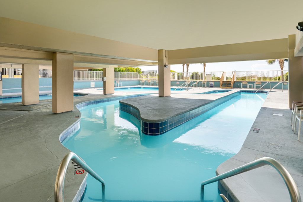 Indoor lazy river and pool with steps to the ocean in background