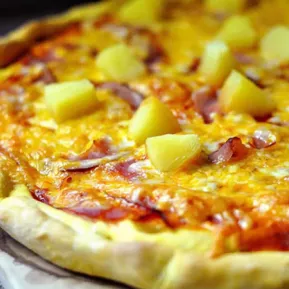 Close up of cheese pizza with pineapple topping