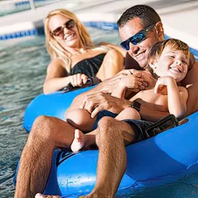 Family of three having fun riding on lazy river