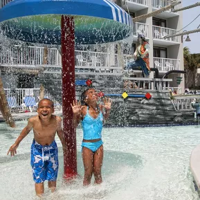 Captain's Quarters kids under waterfall at waterpark