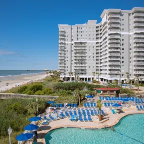 Sea Watch Resort aerial with beach, pool with lounge chairs