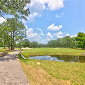 Azalea Sand course with tree and lake among golf cart path