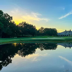 Founder Club at sunrise with fairway, lake and trees