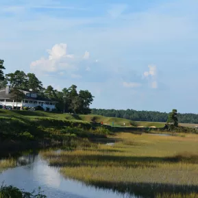 River's Edge Golf with stream and club house