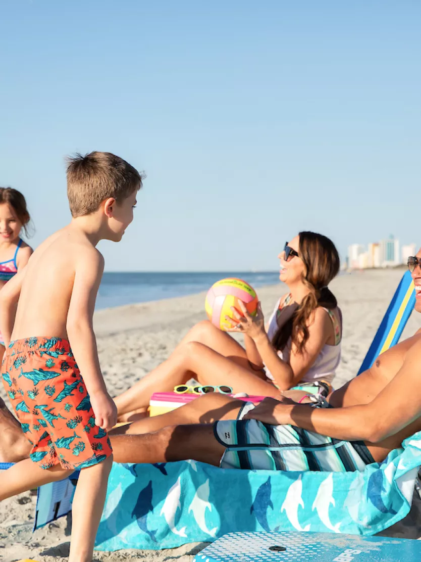 Family playing on the beach