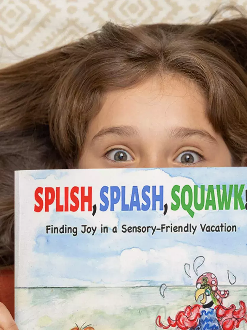 Young girl holding Splish, Splash, Squawk! book
