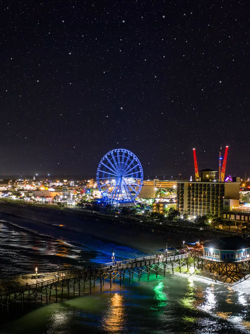 Myrtle Beach's coast lit up at nighttime.