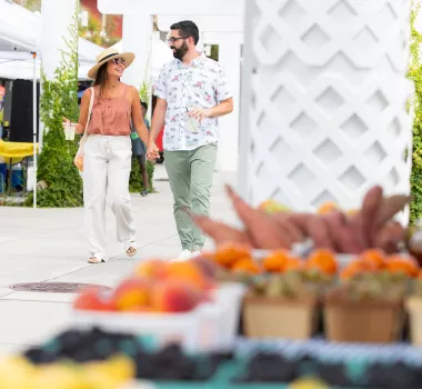 Couple walking through farmers market