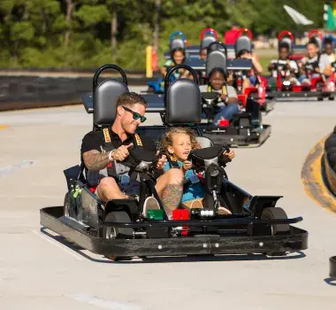 A father and sone race in a Go-Cart at Broadway Grand Prix