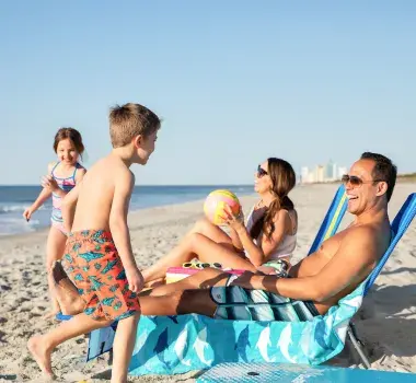 Family playing on the beach