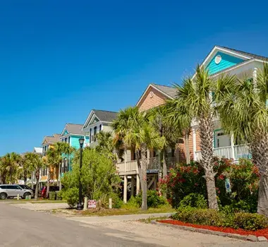 Ocean Blvd. in Surfside Beach with colorful homes and palm trees