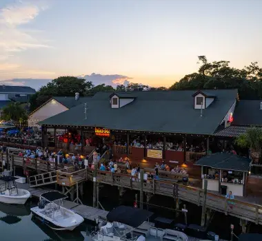 MarshWalk drone shot with the sunset over the restaurants