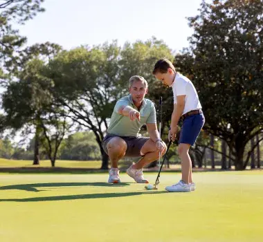Dad and Son playing golf together