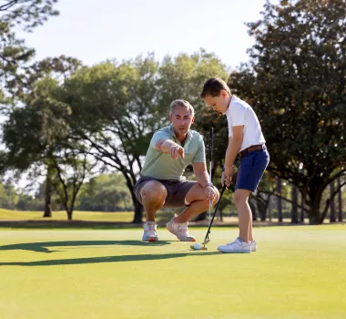 Dad and Son playing golf together