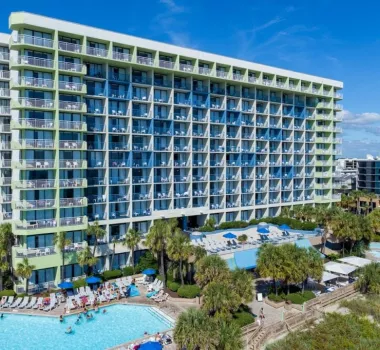 Coral Beach Resort aerial with building and pool