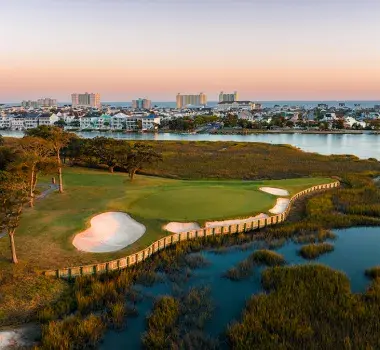Tidwater Golf Club aerial with marsh, city at sunset