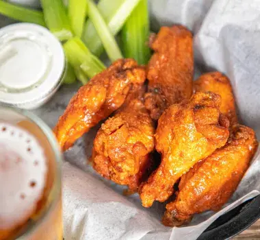 Delicious wings on a place with ranch and celery sticks at Goat Bar and Grill Carolina Forest
