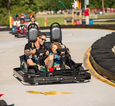 Vistors racing go-karts at the Broadway Grand Prix.