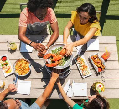 Friends enjoying a meal at Riptydz, an oceanfront restaurant.