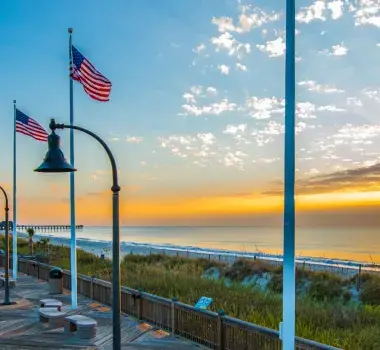 The Myrtle Beach boardwalk waking up to a yellow sunrise.