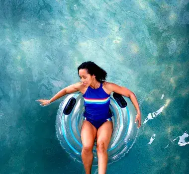 Woman relaxing on a pool float.
