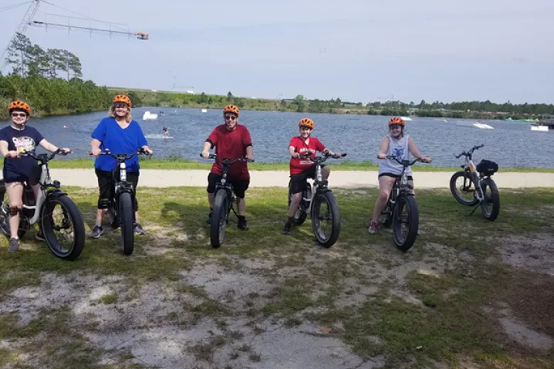 5 people on Electric Bike tour with lake in background