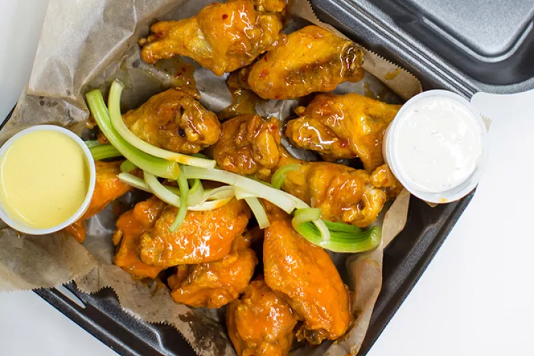 Wings CO wings with sauces in a to go box