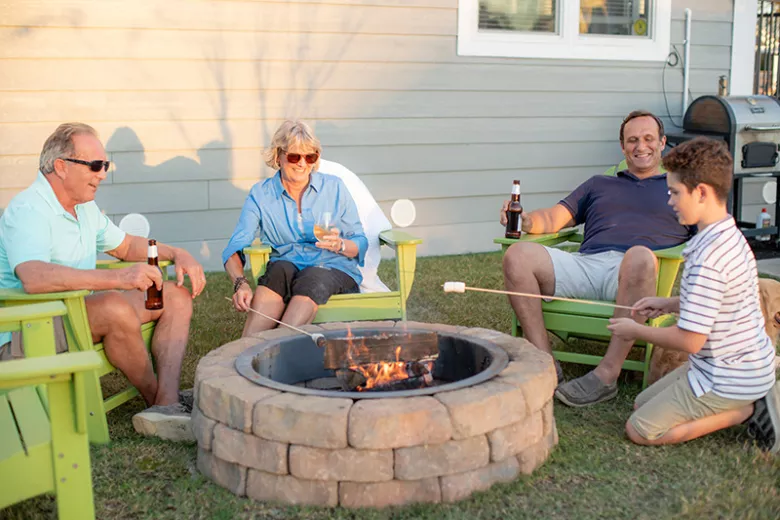 Sun Country family of four around a firepit