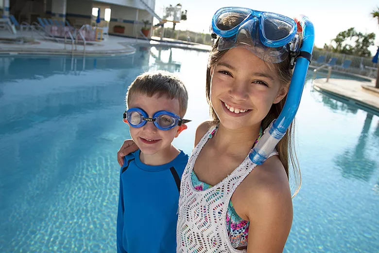 Sea Watch brother and sister standing by pool