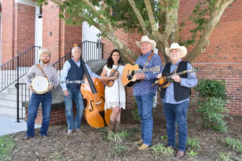 Members of the The End of the Road Bluegrass Band with instruments