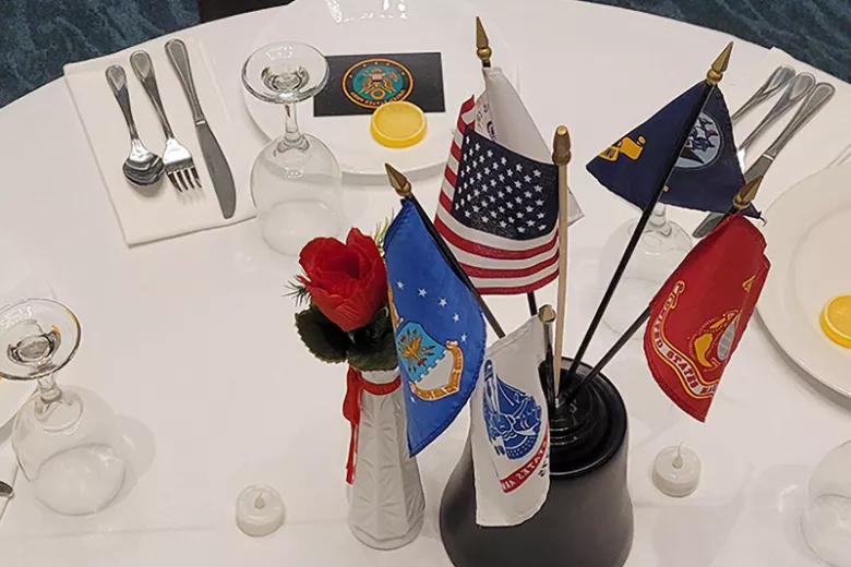 Table with flags and place settings for Missing Man