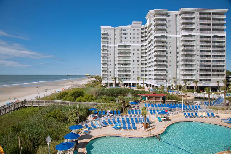 Sea Watch Resort aerial with beach, pool with lounge chairs