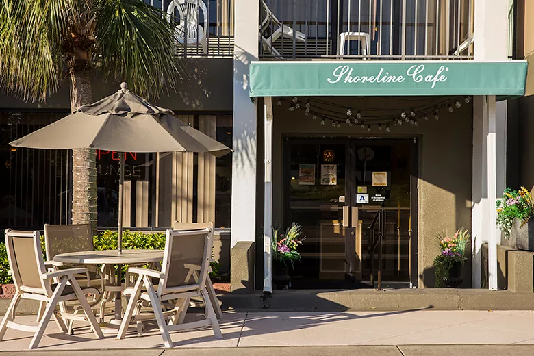 Exterior view of a restaurant with an awning that says Shoreline Cafe