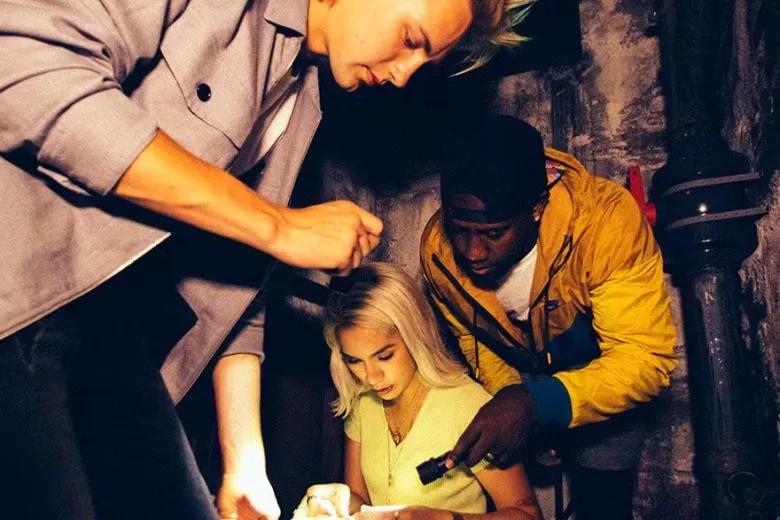 Escape Game Prison Break 3 people looking at item with flashlights