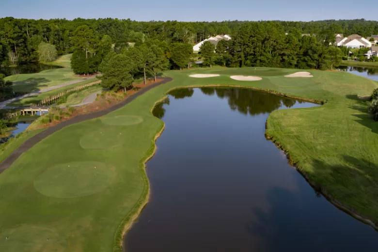 Meadowland aerial with large lake and fairways on each side