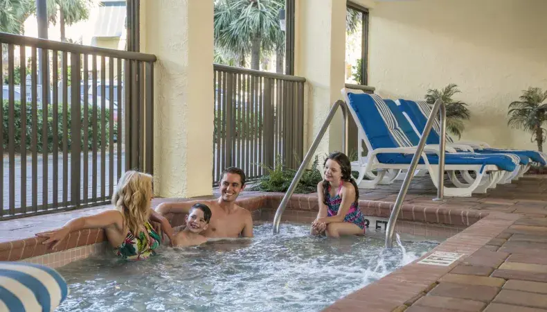 Family sitting in hot tub. Photo 18