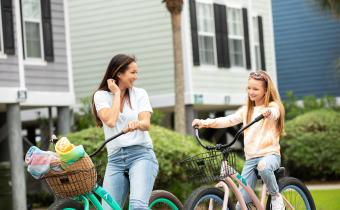 Mom and daughter ride bikes