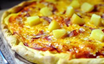 Close up of cheese pizza with pineapple topping