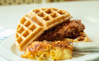 Chicken and Waffles from Croissants with syrup drizzled on top