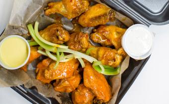 Wings CO wings with sauces in a to go box