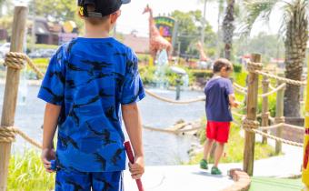 Kids playing mini golf at Jungle Safari course