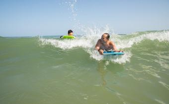 Summer surfing with dad and son